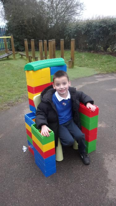 Flamur made a chair using the bricks outside