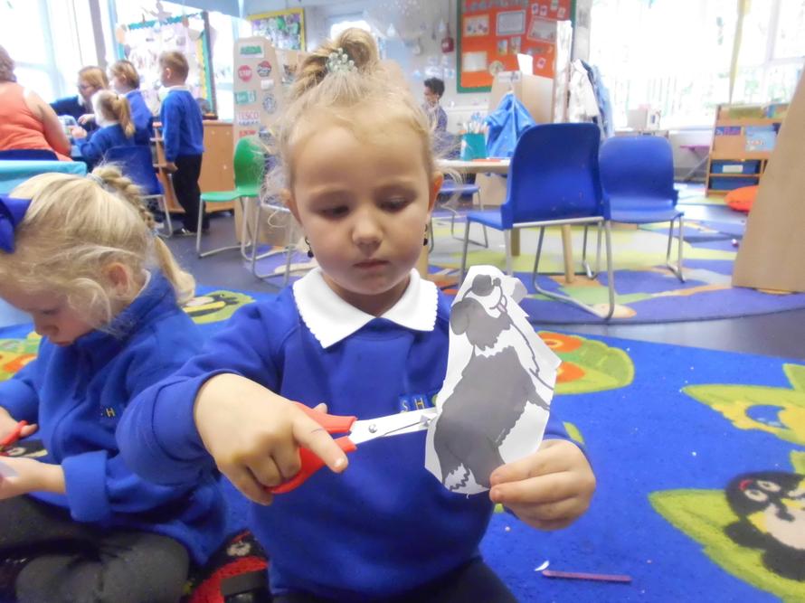 Kylie carefully cutting her puppet out!