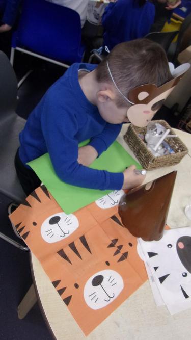 Nicholas is busy writing a birthday card for Fred. 