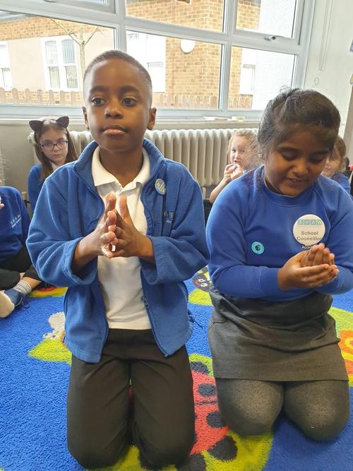 Rubbing hand sanistiser on our hands.