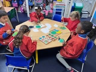 We are painting green leaves for our beanstalk. We mixed colours to find different shades.
