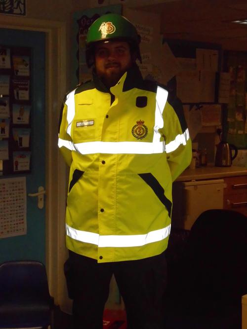 The paramedic coat is yellow with bright stripes