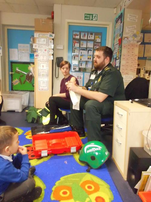 Ross showed the children how to tie a bandage