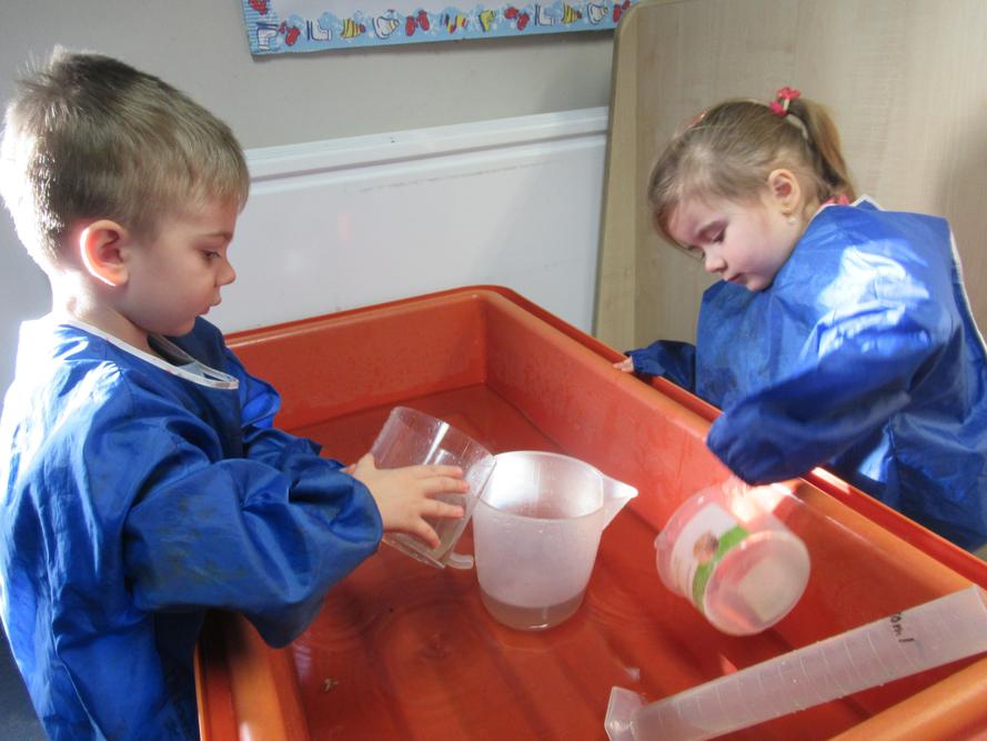 Eduard and Lottie are checking how much water the jugs hold.
