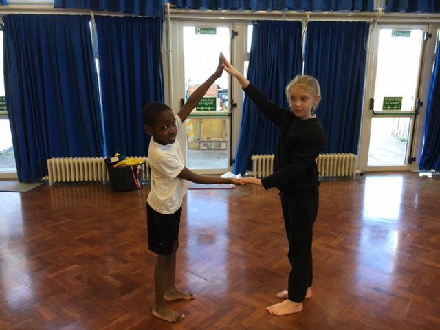 Show me a triangle shape with your partner... 