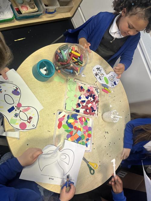 The children used shapes and glitter to decorate their own superhero masks.