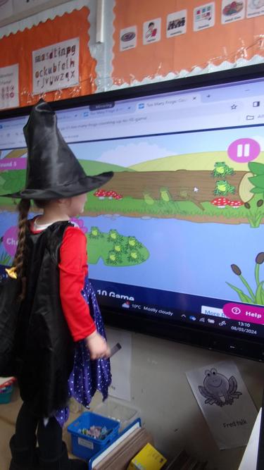 The witch (Layla) practising her maths skills!