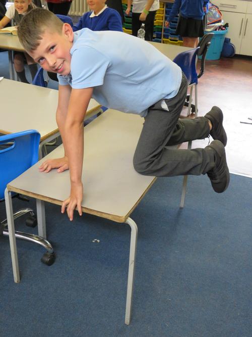 Clambered - Mason clambered onto the table.