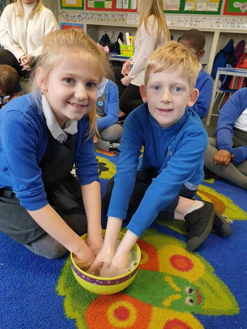 Washing our hands in warm soapy water.