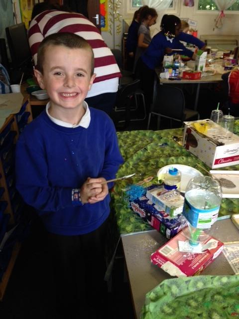 Alfie looks very proud of his boat. 